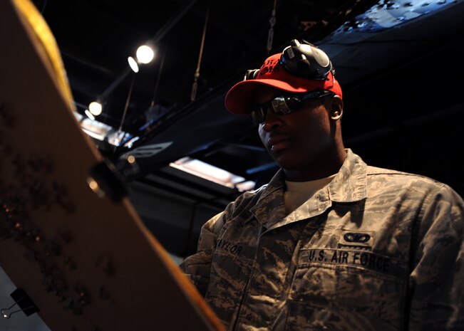 Staff Sgt. Julius Taylor tallies points from the second round of the shootout at the Combat Arms Training and Maintenance range facility opening ceremony Aug. 31, 2010, on Joint Base Charleston, S.C. Participants shot at targets with different point values from six to 10 to determine a winner. Sergeant Taylor is a CATM instructor with the 628th Security Forces Squadron. (U.S. Air Force photo/Senior Airman Timothy Taylor)