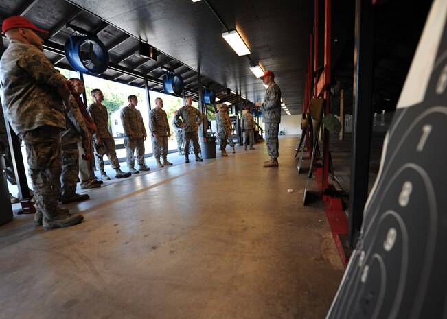 Staff Sgt. John Foster announces the winner of the M-9 shoot off at the Combat Arms Training and Maintenance range facility opening ceremony Aug. 31, 2010, on Joint Base Charleston, S.C. Nine military participants shot off three magazines at varying distances and times from seven meters in 10 seconds, 15 meters in 12 seconds, and 25 meters in 15 seconds. The winner of the competition was Chief Master Sergeant Garth Freund from the 628th Security Forces Squadron with a score of 281 hits out of a possible 300. (U.S. Air Force photo/Senior Airman Timothy Taylor)