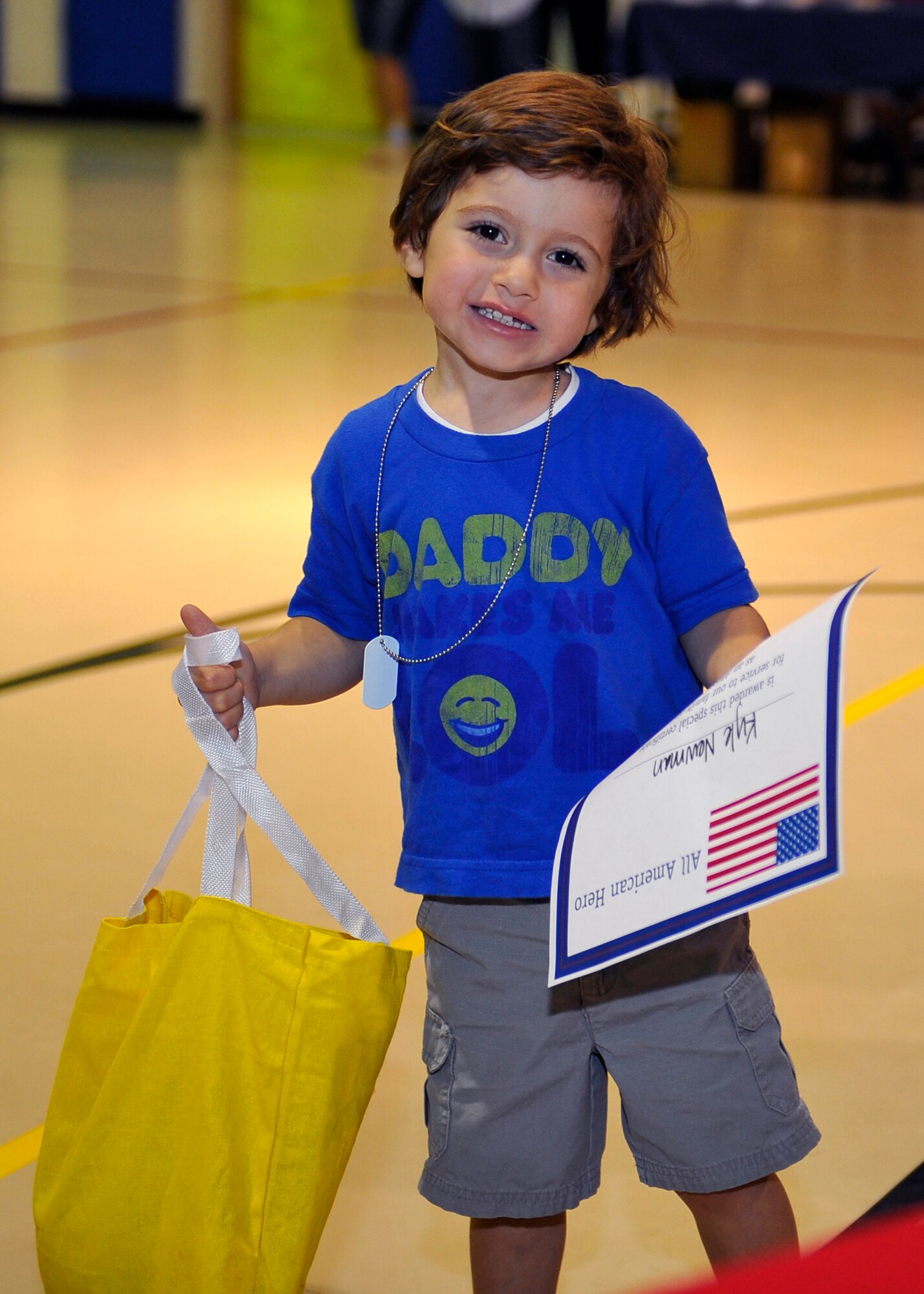 HOLLOMAN AIR FORCE BASE, N.M. -- Kyle Newman, son of Senior Airman Trenton Newman, 49th Civil Engineer Squadron, poses for a photo after getting his hero pack and dog tags at the Young Heroes Deployment Expo Aug. 28, 2010. Children who attended the expo also received a certificate that recognized them for being one of Holloman's youngest heroes and thanked them for their service. The Airman and Family Readiness Center hosted the event to honor children with parents who are preparing to deploy or who are currently deployed. (U.S. Air Force photo by Senior Airman Veronica Stamps / Released)
