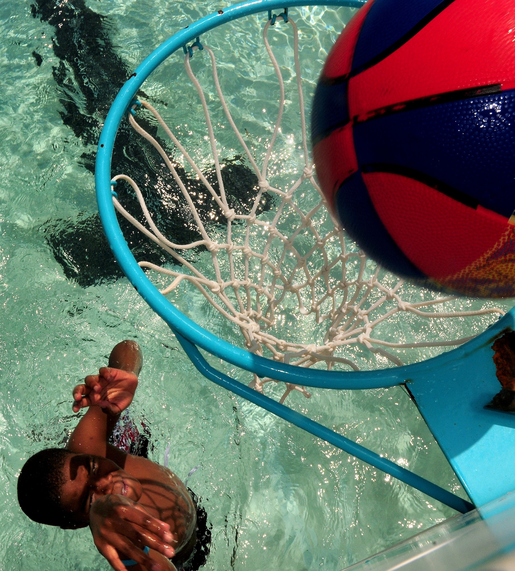 Romello Cypress scores on the rebound at the base pool during the Year of the Air Force Family finale on Joint Base Charleston, S.C., Aug. 28, 2010. While Romello and other children kept the court action up in the pool, families with younger children stayed clear and waded in the baby pool. Romello is the son of U.S. Air Force Tech. Sgt. Yolandra Cobb who is a military training leader with the 373rd Training Squadron. (U.S. Air Force photo/Staff Sgt. Daniel Bowles)