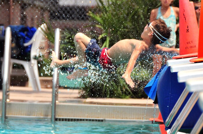 Case Pohle catches some air while playing on the water slide at the base pool on Joint Base Charleston, S.C., Aug. 28, 2010. The slide provided hours of free fun for children eager to make a splash during the Year of the Air Force finale. Case is the son of U.S. Air Force Maj. Patrick Pohle who is the Mental Health Flight commander for the 628th Medical Operations Squadron. (U.S. Air Force photo/Staff Sgt. Daniel Bowles)