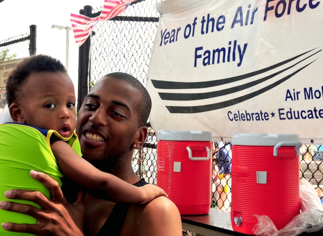 U.S. Air Force Airman 1st Class Samuel Lewis takes a lunch break during the Year of the Air Force finale with his son Timothy at the base pool on Joint Base Charleston, S.C., Aug. 28, 2010. During the finale, free food and drink was provided, keeping hungry mouths fed and bodies ready for fun. Airman Lewis is a crew chief with the 315th Aircraft Maintenance Squadron. (U.S. Air Force photo/Staff Sgt. Daniel Bowles)