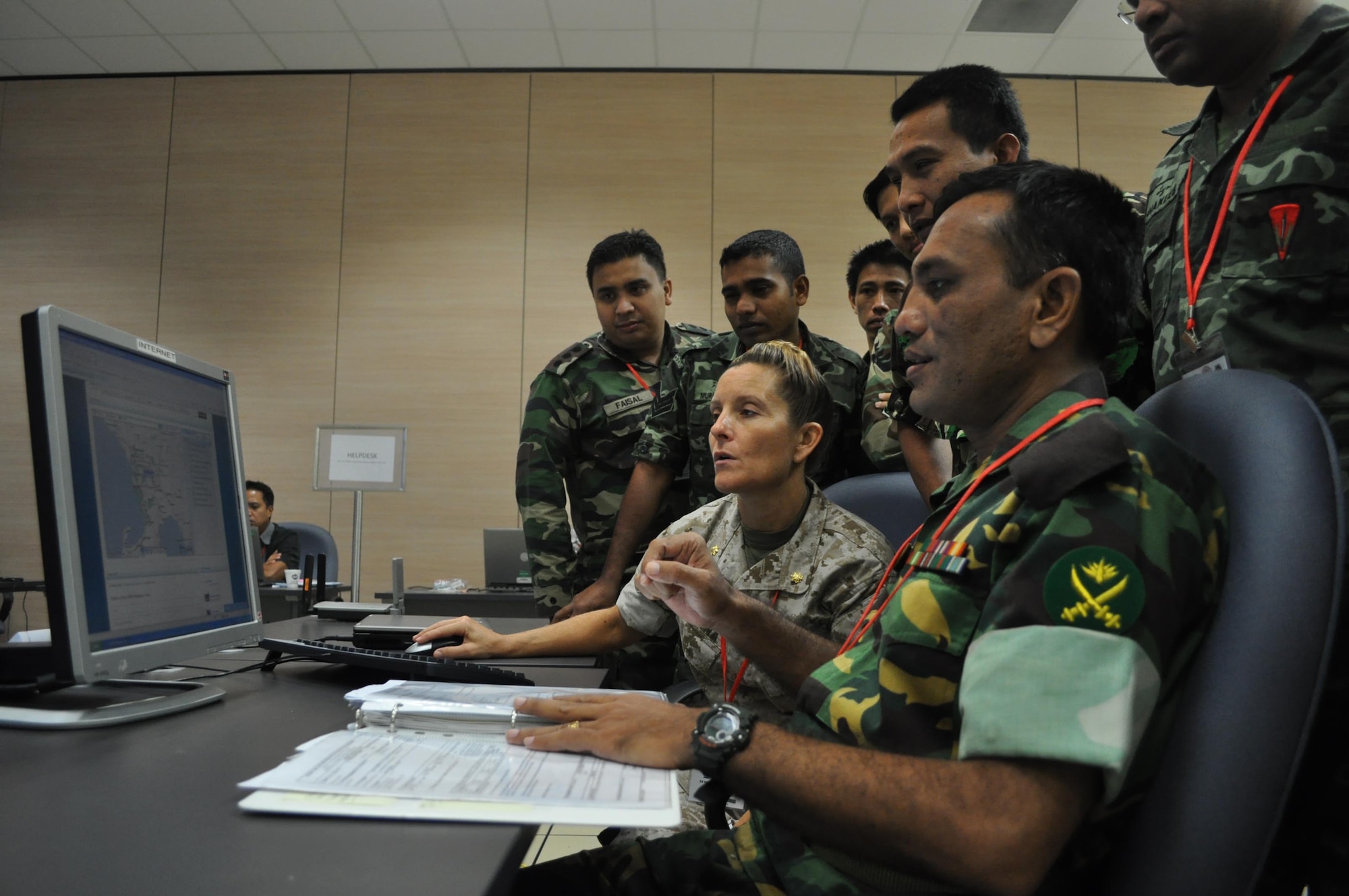 CHANGI VILLAGE, Singapore (Aug. 26, 2010) U.S. Marine Maj. Heidi McKenna, assigned to Marine Forces Pacific, listens to a field report for the current operations team during Pacific Endeavor workshop. Pacific Endeavor is a multinational communication workshop bringing together 16 Asia-Pacific nations to discuss communication interoperability, share best practices, and test their abilities to rapidly respond to a disaster scenario. (U.S. Navy photo by Lt. Theresa Donnelly/released)