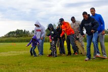 MINOT AIR FORCE BASE, N.D. – Airman and family members participate in a game called “the buddy walk” which promotes teamwork and communication at Bud Ebert Park during Operation Heroes here Aug. 28. More than 300 service members and their families participated in the fourth annual event. Operation Heroes is a virtual deployment for military children and spouses, giving them the opportunity to see what parents and spouses experience prior to and during a deployment. (U.S. Air Force photo by Airman 1st Class Aaron-Forrest Wainwright)