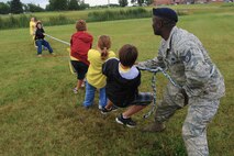 MINOT AIR FORCE BASE, N.D. --Children participating in Operation Heroes challenge Staff Sgt. Jameli Collins, 5th Security Forces Squadron member, in a game of tug of war at Bud Ebert Park during Operation Heroes here Aug. 28. More than 300 service members and their families participated in the fourth annual event. Operation Heroes is a virtual deployment for military children and spouses, giving them the opportunity to see what parents and spouses experience prior to and during a deployment. (U.S. Air Force photo by Airman 1st Class Aaron-Forrest Wainwright)