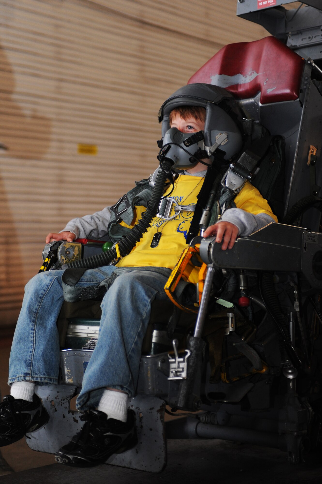 MINOT AIR FORCE BASE, N.D. -- Brandon Regina, son of Staff Sgt. Andrea Regina, 741st Missile Security Forces Squadron member, is equipped with flight equipment as he sits in a B-52H Stratofortress pilot seat, as part Operation Heroes here Aug. 28. More than 300 service members and their families participated in the fourth annual event. Operation Heroes is a virtual deployment for military children and spouses, giving them the opportunity to see what parents and spouses experience prior to and during a deployment. (U.S. Air Force photo by Airman 1st Class Aaron-Forrest Wainwright)