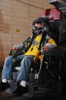 MINOT AIR FORCE BASE, N.D. -- Brandon Regina, son of Staff Sgt. Andrea Regina, 741st Missile Security Forces Squadron member, is equipped with flight equipment as he sits in a B-52H Stratofortress pilot seat, as part Operation Heroes here Aug. 28. More than 300 service members and their families participated in the fourth annual event. Operation Heroes is a virtual deployment for military children and spouses, giving them the opportunity to see what parents and spouses experience prior to and during a deployment. (U.S. Air Force photo by Airman 1st Class Aaron-Forrest Wainwright)