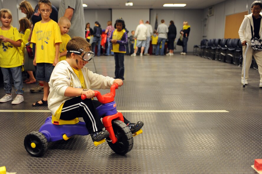 MINOT AIR FORCE BASE, N.D. -- Hayden Williams, son of Master Sgt. Mark Williams, 91st Missile Security Forces Squadron flight chief, demonstrates the dangers of drunk driving by wearing “beer goggles” during Operation Heroes here Aug. 28. More than 300 service members and their families participated in the fourth annual event. Operation Heroes is a virtual deployment for military children and spouses, giving them the opportunity to see what parents and spouses experience prior to and during a deployment. (U.S. Air Force photo by Airman 1st Class Aaron-Forrest Wainwright)