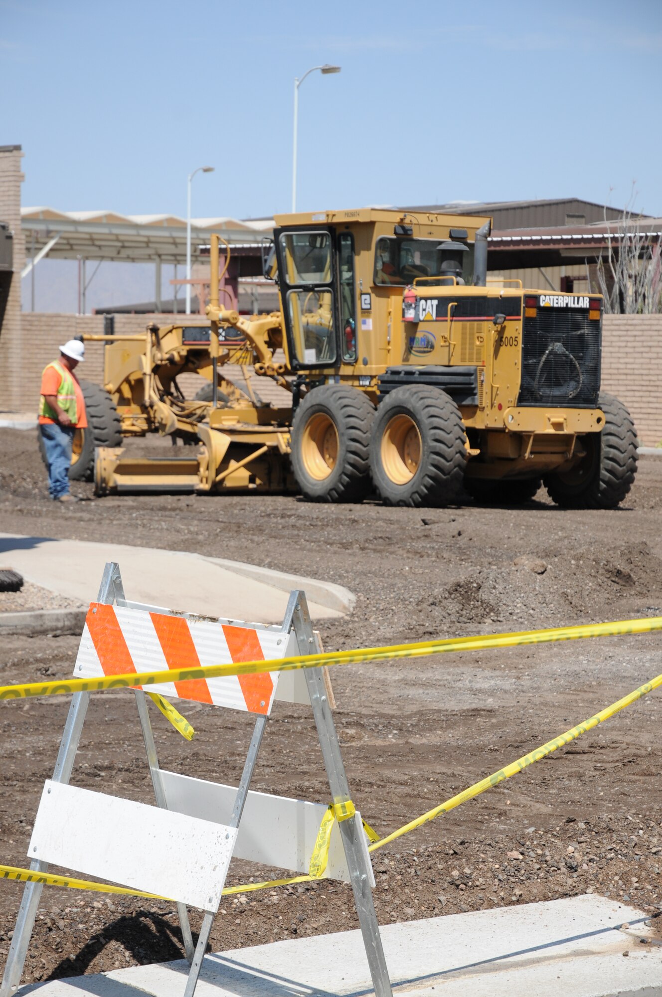 MRM Construction Service, Inc., a woman-owned heavy civil construction firm based out of Phoenix, Ariz., prepares the 944th Security Forces Squadron's parking lot for re-paving by removing the old asphalt before grading on July 14, 2010.  The construction firm landed a $12.7M in Luke stimulus contracts.  The 944th SFS parking lot is one of the many parking lot projects that will occur around the 944th Fighter Wing this summer.  (U.S. Air Force photo/Staff Sgt. Denise Willhite)