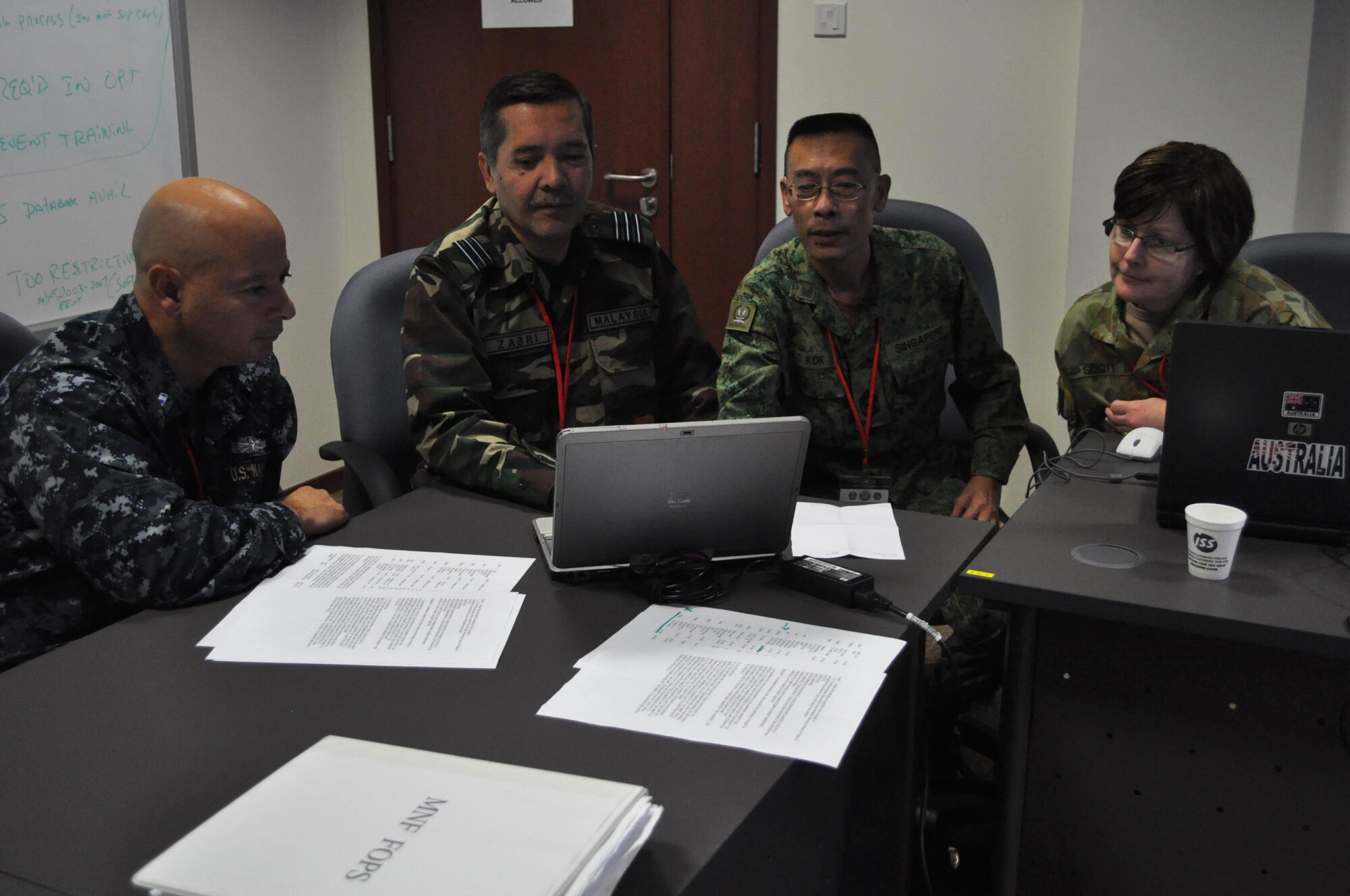 CHANGI VILLAGE, Singapore (Aug. 26, 2010) A multinational military team with military  representatives from the U.S. Navy, Malaysia, Singapore and Australia put together a disaster planning strategy during Pacific Endeavor workshop. Pacific Endeavor, hosted by U.S. Pacific Command and the Singapore Armed Forces brought together 16 Asia-Pacific countries, members of the humanitarian community and private industry. The aim of the workshop was to develop agreed upon communication procedures while responding to major natural disasters. (U.S. Navy photo by Lt. Theresa Donnelly/released)

