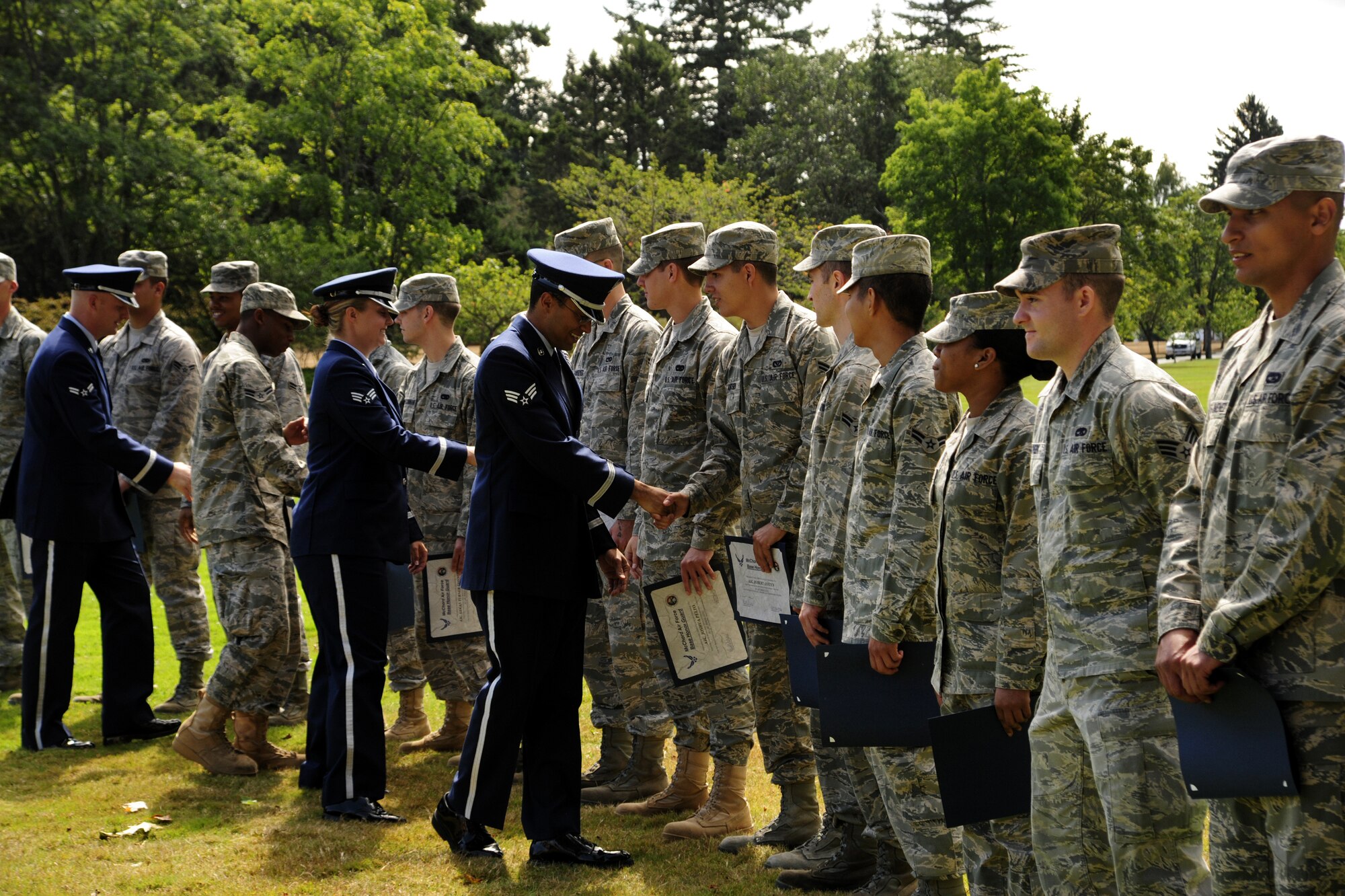 The newest members of the 62nd Airlift Wing Honor Guard are congratulated by their instructors at an Honor Guard graduation ceremony Aug. 30 at Joint Base Lewis-McChord, Wash. (U.S. Air Force Photo/Airman Leah Young)