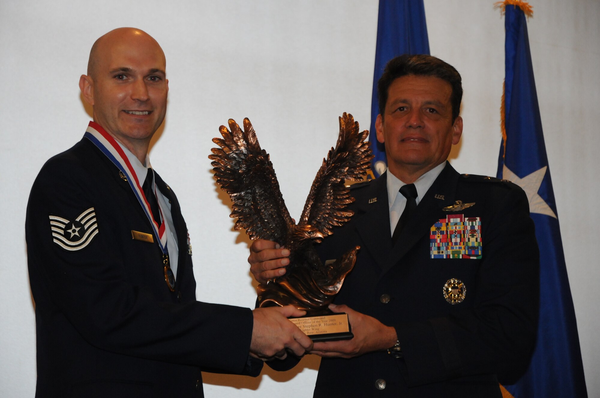Tech. Sgt. Stephen Hunter, 944th Civil Engineer Squadron explosive ordnance disposal technician, receives the Air Force Reserve Command's NCO of the Year award from Maj. Gen. Frank Padilla, 10th Air Force commander, during a ceremony Aug. 24, 2010, at the Luke Air Force Base, Ariz.  Sergeant Hunter was selected as one of the Air Force's 12 Outstanding Airmen of the Year for 2010.  He will receive those accolades during a ceremony in Washington, D.C. in September.  (U.S. Air Force photo/Tech. Sgt. Susan Stout)