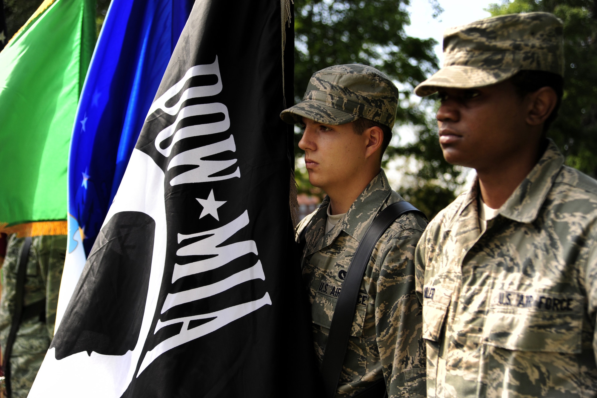 Airman 1st Class Corey Miller, assigned to the 62nd Communications Squadron, and Airman 1st Class Robert Antsen, assigned to the 62nd Civil Engineer Squadron, perform color guard detail during an Honor Guard graduation ceremony Aug. 30 at Joint Base Lewis-McChord, Wash. (U.S. Air Force Photo/Airman Leah Young)