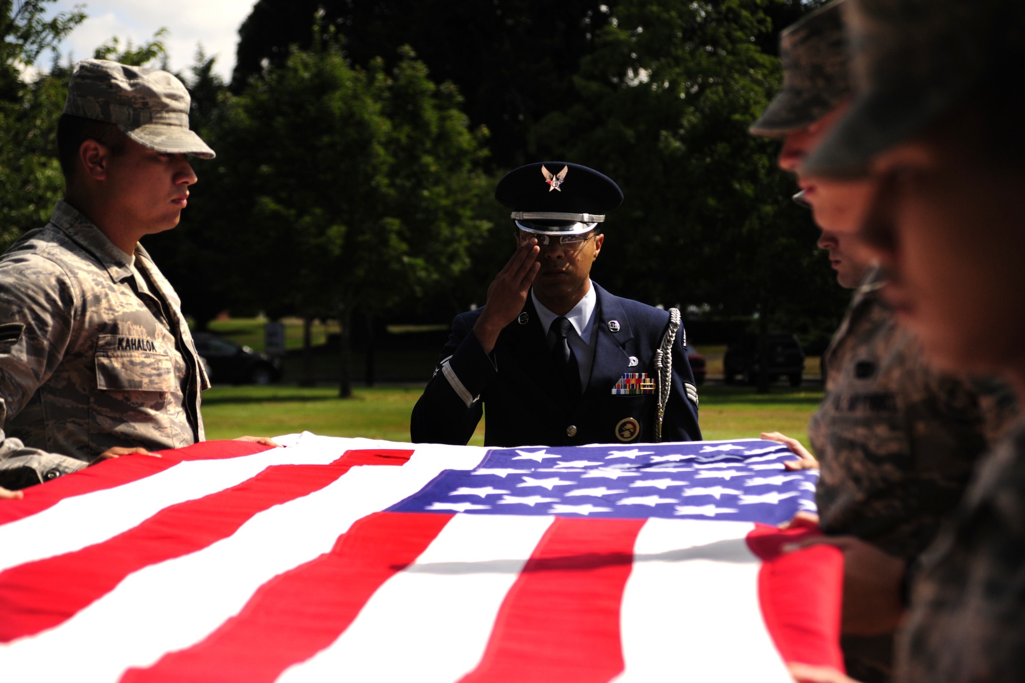 Members of the 62nd Airlift Wing Honor Guard team demonstrate a flag folding ceremony during an Honor Guard graduation ceremony Aug. 30 at Joint Base Lewis-McChord, Wash. (U.S. Air Force Photo/Airman Leah Young)
