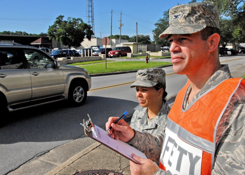 Col. Michael Gantt, 53rd Wing commander, performs a routine seatbelt check on a busy street corner on Eglin Air Force Base, Aug. 31.  Each month during the 101 Critical Days of Summer, 53rd Wing units conducted seatbelt checks on 50 passengers.  The surveys are part of Air Combat Command’s seatbelt compliance initiatives.  As part of the 101 CDS, the 53rd created the Commander Safety Cup Challenge, a Wing-wide competition where small, medium, and large organizations compete for the infamous Commander Safety Cup in each size category.   The CC Cup Challenge pits organizations competing to accrue points in ten events including 101 CDS Kick-off briefings, a slogan contest, safety briefings, seat belt surveys,  etc.  (U.S. Air Force photo/Samuel King Jr.)