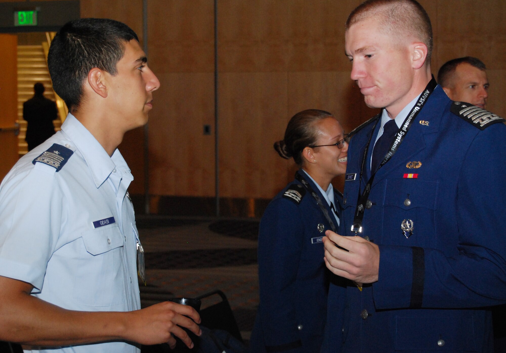 Cadets 1st Class Daniel Gidasi, left, and Hal Schmidt talk before a presentation on the Air Force Academy's unmanned aerial systems airmanship program at the Unmanned Systems North America conference in Denver Aug. 27, 2010. Cadet Schmidt, a native of Cody, Wyo., presented information on the Academy's research programs. (U.S. Air Force photo/Staff Sgt. Don Branum)