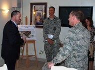 LAUGHLIN AIR FORCE BASE, Texas – Lt. Col. Dee Katzer, 47th Civil Engineering Squadron commander, presents a plan to rebuild Laughlin’s enlisted dormitories to Erasmo Valles, a staffer from Congressman Ciro Rodriguez’s office, as Col. Michael Frankel, 47th Flying Training Wing commander, and Alissa Tovar, legislative assistant to Congressman Rodriguez, look on. The team spent the morning of Aug. 27 touring numerous Laughlin facilities including the dorms, the Aircraft Maintenance Operations Center and the simulator building. (U.S. Air Force photos/Airman 1st Class Blake Mize)