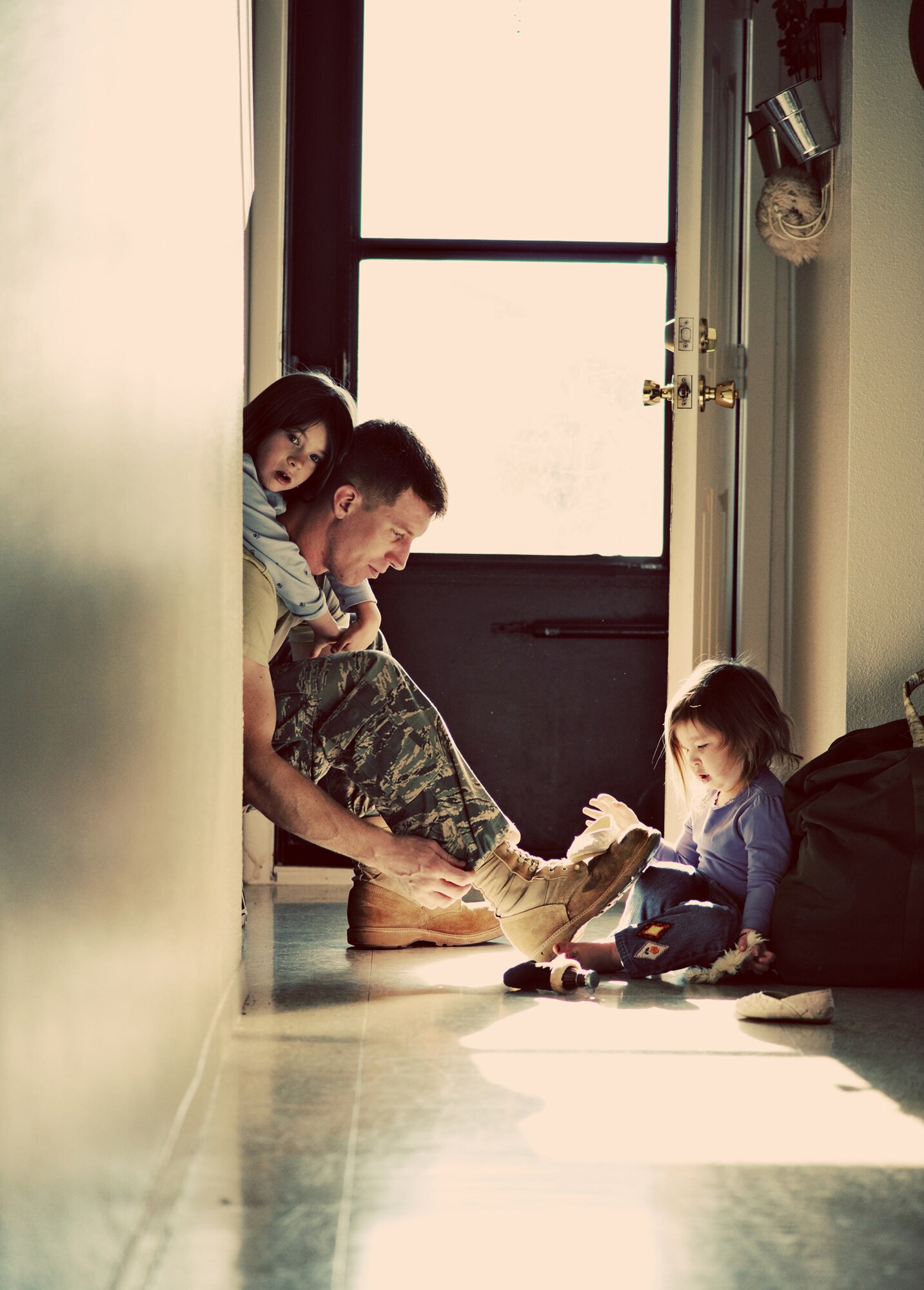 Andrea Hubbard captured her husband, Tech. Sgt. Daniel Hubbard, and their children, as he prepared to go to work at Cannon Air Force Base, N.M. The photo, "Morning with Daddy," captured first place in the MyAirForceLife.com contest, and earned her new camera equipment and a showing of her photograph at the Pentagon. (Courtesy photo by Andrea Hubbard)