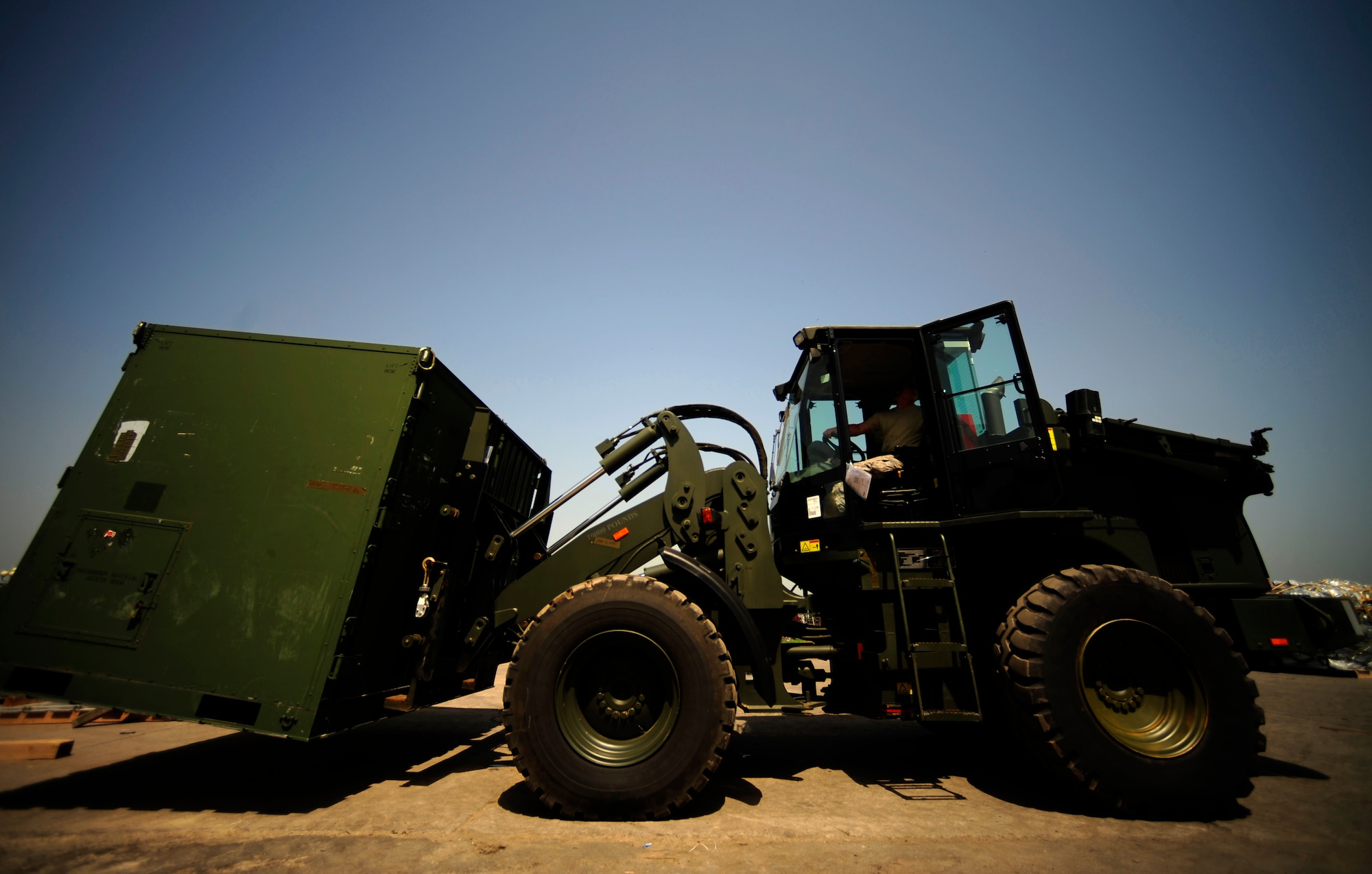 CHAKLALA AIR FORCE BASE, Pakistan – U.S. Air Force Airmen from the Contingency Response Element, 818th Contingency Response Group, Joint Base McGuire-Dix-Lakehurst, N.J., operates a forklift while transporting equipment containers off the flightline at Chaklala Air Base, Pakistan, on Aug. 28. The CRE arrived to take over responsibilities for loading and off loading U.S. aircraft with supplies all over Pakistan in support of flood relief efforts. (U.S. photo taken by Staff Sgt. Andy M. Kin) (released)
