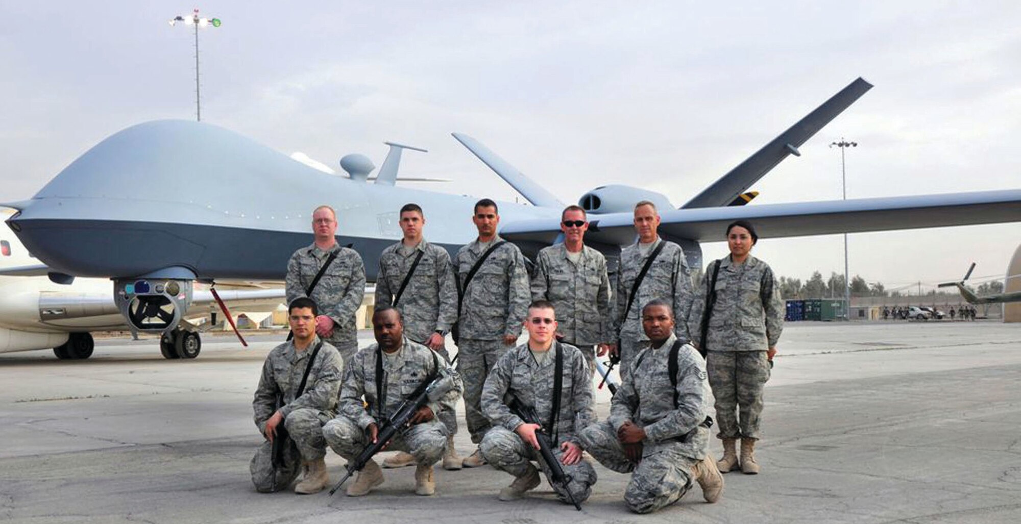 TRAVIS AIR FORCE BASE, Calif. -- Senior Master Sgt. Thews, along with airmen from the from the 860th Aircraft Maintenance Squadron, 945th AMXS and 60th Logistics Readiness Squadron, pose in front of an Unmanned Aerospace Vehicle called the MQ-9 Reaper aircraft. 
Left to right starting with the back row: Senior Airmen Benjamin Propst, 860 AMXS, Michael Wendlinger, 945 AMXS, Saverio DeMitri, 860 AMXS,  Senior Master Sgt. Darren Thews, 945 AMXS, Tech. Sgt. Timothy Stotenburg, 945 AMXS, and Senior Airman Jazmin Gonzalez, 60 LRS. Front row left to right: Senior Airman Miles Stidham, 860 AMXS, Master Sgt. Kizer Davidson, 945 AMXS, Senior Airman Ryan Esparza, 860 AMXS, and Staff Sgt. Carlos Lewis, 60 LRS. (Air Force photo courtesy of Senior Master Sgt. Darren A. Thews) 