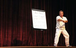 Comedian Steve Verret performs his stand-up routine for Airmen Aug. 26, 2010, on Joint Base Charleston, S.C. Mr. Verret's message is designed to promote safe driving and traffic safety awareness in an enthusiastic and relaxed setting with a twist from his Cajun comedy routine. Mr. Verret provided information ranging from types of car insurance to giving examples of how one mistake could affect the rest of an Airman's life. (U.S. Air Force photo/Airman 1st Class Ian Hoachlander)