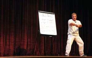 Comedian Steve Verret performs his stand-up routine for Airmen Aug. 26, 2010, on Joint Base Charleston, S.C. Mr. Verret's message is designed to promote safe driving and traffic safety awareness in an enthusiastic and relaxed setting with a twist from his Cajun comedy routine. Mr. Verret provided information ranging from types of car insurance to giving examples of how one mistake could affect the rest of an Airman's life. (U.S. Air Force photo/Airman 1st Class Ian Hoachlander)