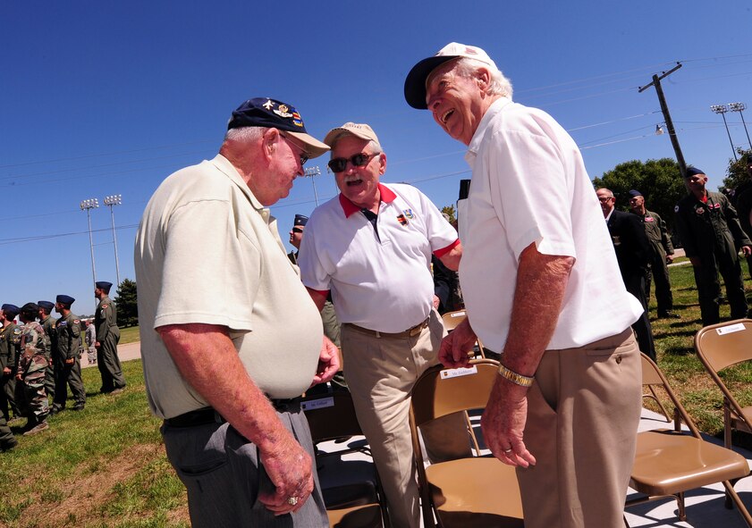 OFFUTT AIR FORCE BASE, Neb. - (Center) Retired Brig. Gen. Regis F.A. Urschler talks with former 55th Fighter Group members (left) George Eichhorn and Don Gifford at a plaque rededication ceremony Aug. 27 in front of the 55th Wing and 55th Operations Group headquarters. The memorial plaque honors the heroic efforts of the fighter group. U.S. Air Force photo by Josh Plueger
