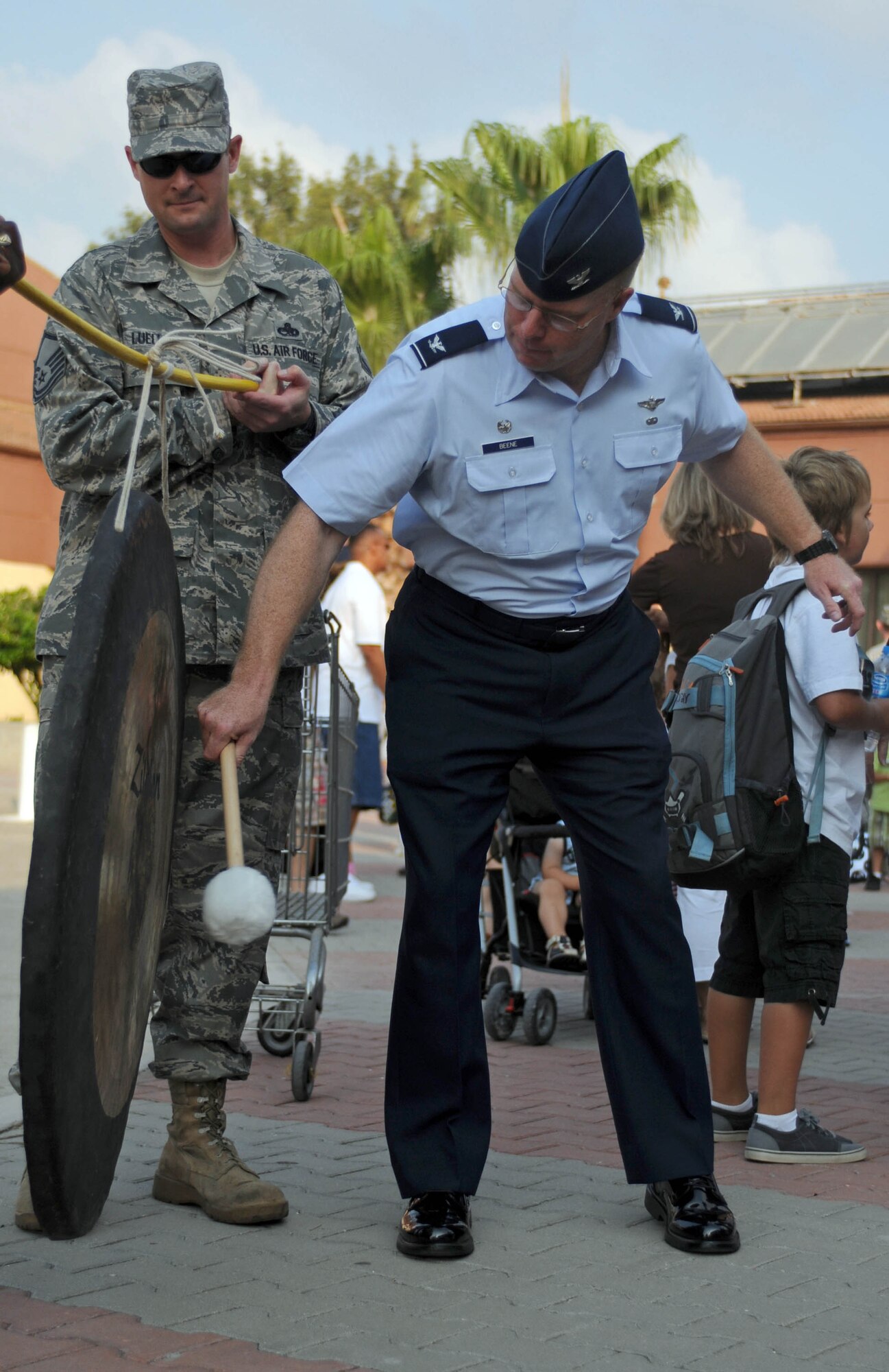 Col. Eric Beene, 39th Air Base Wing commander, bangs the gong to start the first day of the new school year at Incirlik Unit School Aug. 30, 2010. More than 550 high school, middle school and elementary school students returned after their summer break with more than a 75 percent student turnover because of summer assignments.  (U.S. Air Force photo /Senior Airman Sara Csurilla)
