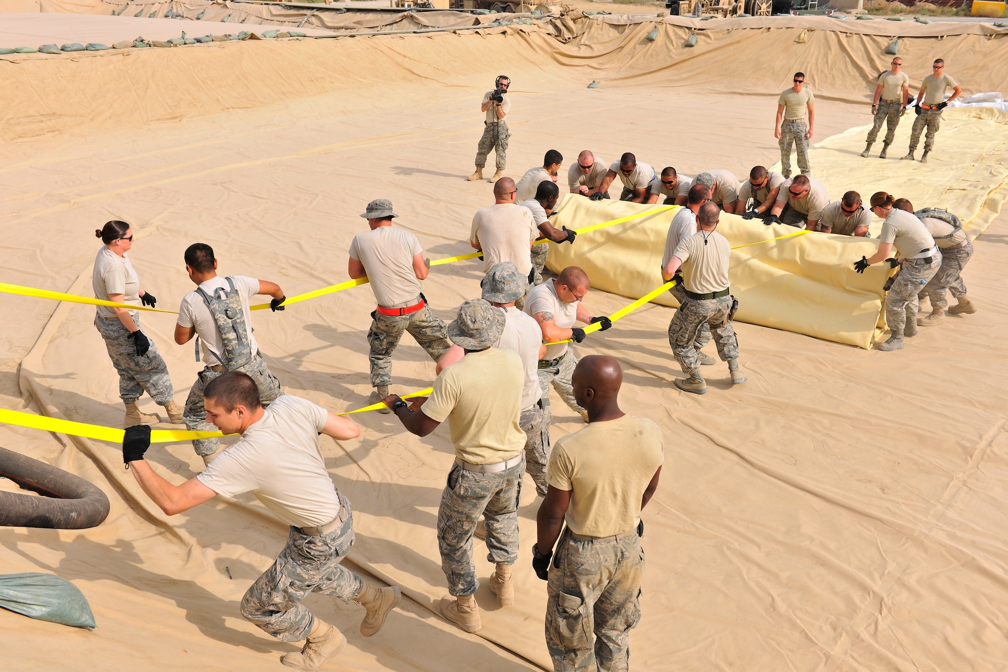 Airmen assigned to the 455th Expeditionary Logistics Readiness Squadron unfurl a new fuel bladder at Bagram Airfield, Afghanistan, Aug. 31. 2010. The new fuel bladder can hold 200,000 gallons of jet fuel.  (U.S. Air Force photo/Staff Sgt. Christopher Boitz)