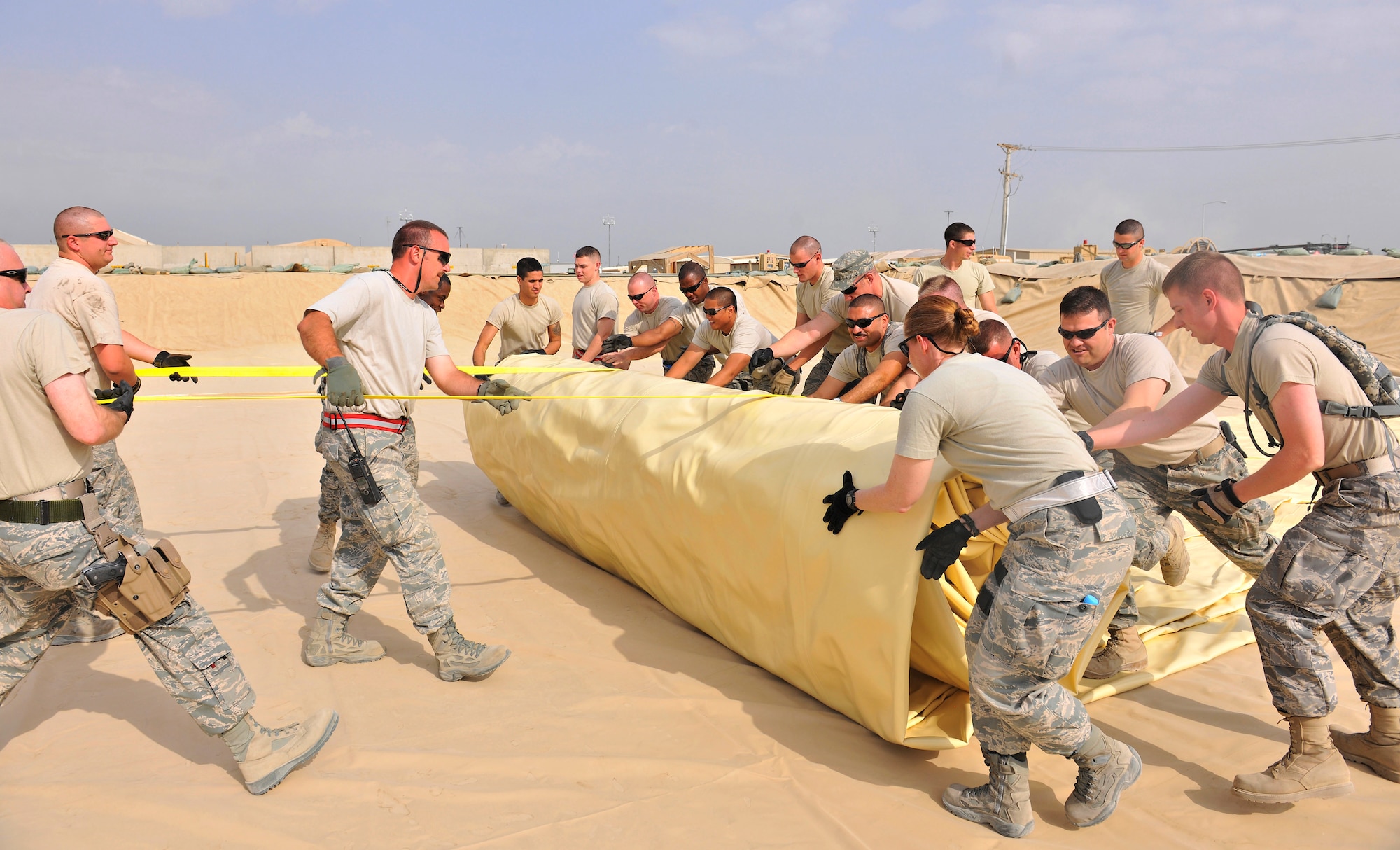 Airmen assigned to the 455th Expeditionary Logistics Readiness Squadron unfurl a new fuel bladder at Bagram Airfield, Afghanistan, Aug. 31. 2010. The new fuel bladder can hold 200,000 gallons of jet fuel.  (U.S. Air Force photo/Staff Sgt. Christopher Boitz)