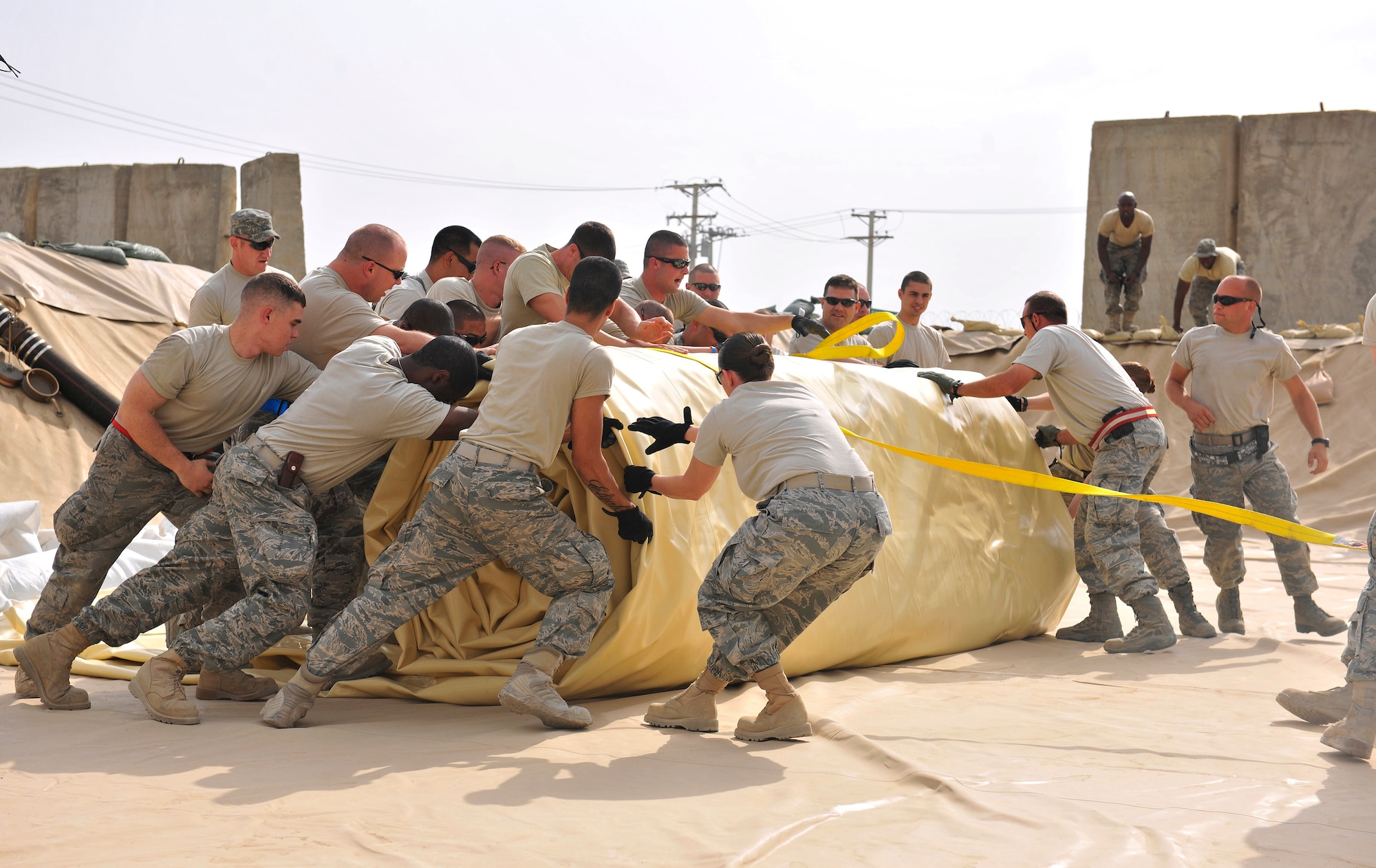 Airmen assigned to the 455th Expeditionary Logistics Readiness Squadron unfurl a new fuel bladder at Bagram Airfield, Afghanistan, Aug. 31. 2010. The new fuel bladder can hold 200,000 gallons of jet fuel.  (U.S. Air Force photo/Staff Sgt. Christopher Boitz)