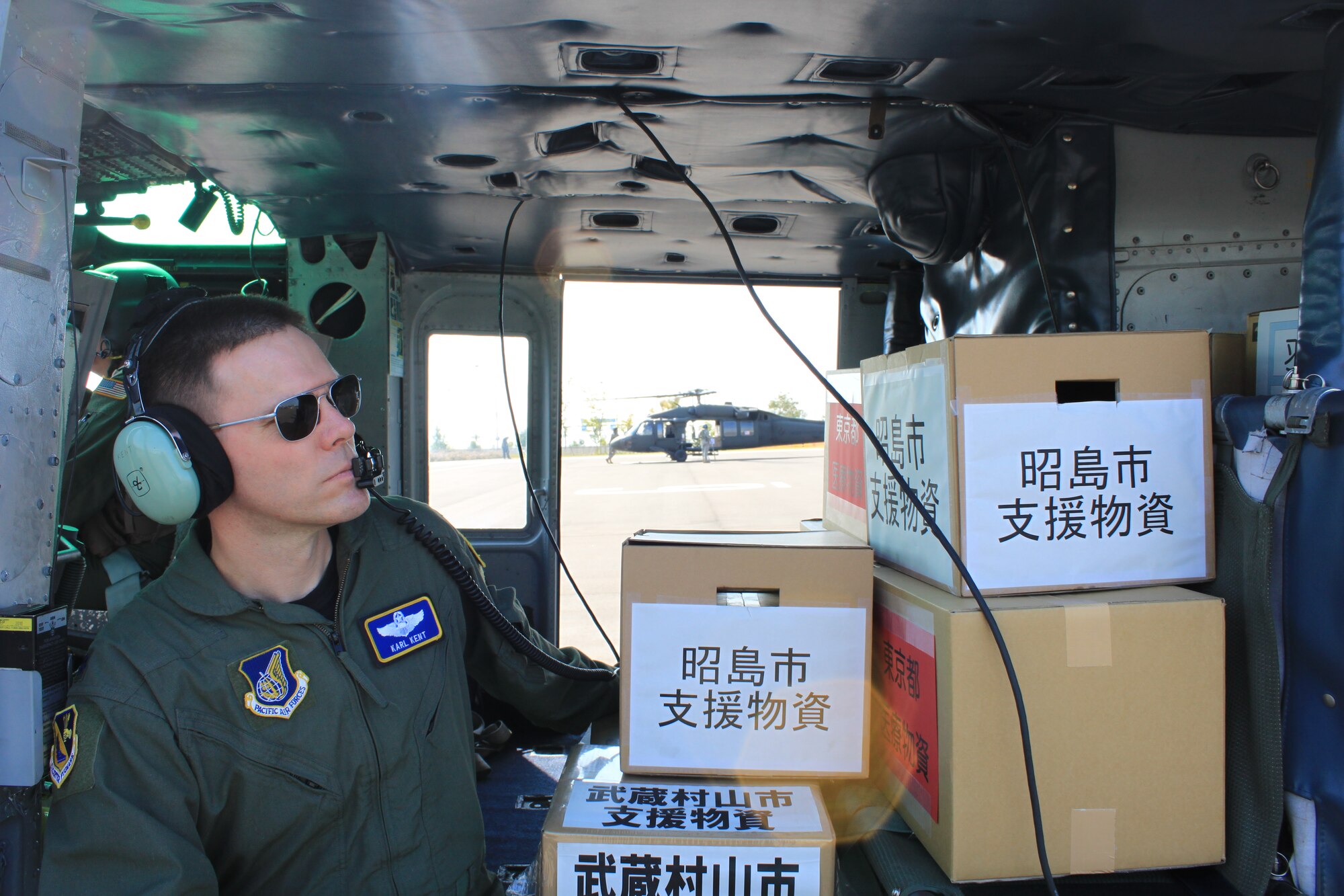 YOKOTA AIR BASE, Japan -- As part of the TMG disaster preparedness drill, Lt. Col. Karl Kent, 374th Airlift Wing chief of Plans and Programs, waits inside a Yokota UH-1 to offload supplies in downtown Tokyo, 29 Aug. The drill demonstrated the capabilities of U.S. and Japanese governments to provide humanitarian relief in the event of a natural disaster in the greater Tokyo area. (courtesy photo)