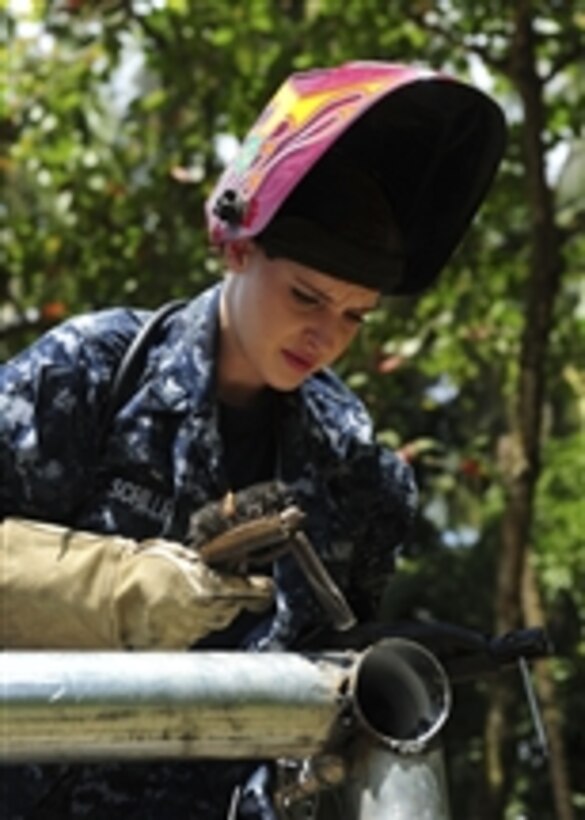 U.S. Navy Petty Officer 3rd Class Yanina Schiller, a hull maintenance technician assigned to the multipurpose amphibious assault ship USS Iwo Jima (LHD 7), examines welds she made on galvanized pipes for a new fence at a school during a community relations project in Limon, Costa Rica, on Aug. 27, 2010.  The Iwo Jima is in Costa Rica in support of Continuing Promise, a humanitarian civic assistance mission.  Assigned medical and engineering staff embarked aboard the ship worked with partner nation teams to provide medical, dental, veterinary and engineering assistance to eight nations.  