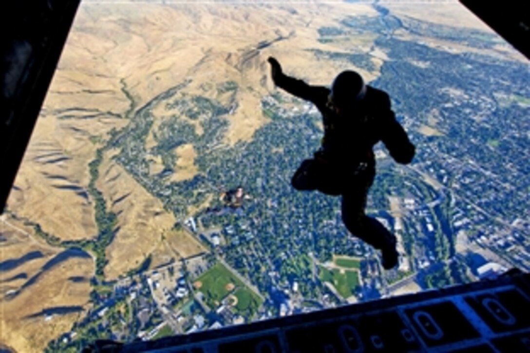 Members of the U.S. Navy parachute demonstration team, the Leap Frogs, jump out of a Kentucky Air National Guard C-130 H2 Hercules aircraft above the Idaho State Capitol during Boise Navy Week in Boise, Idaho, Aug. 25, 2010. Navy weeks are designed to show Americans the investment they have made in their Navy and increase awareness in cities that do not have a significant Navy presence. 