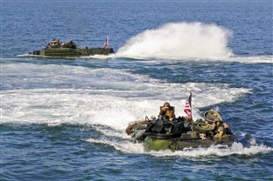 U.S. Navy amphibious assault vehicles prepare to enter the well deck of the amphibious dock landing ship USS Carter Hall at sea in the Atlantic Ocean, Aug. 30, 2010. The Carter Hall is part of the Kearsarge Amphibious Ready Group, which is en route to Pakistan to help provide relief to flood-stricken regions. The 26th Marine Expeditionary Unit is deploying early to the region to support the ongoing humanitarian aid and disaster-relief operations.