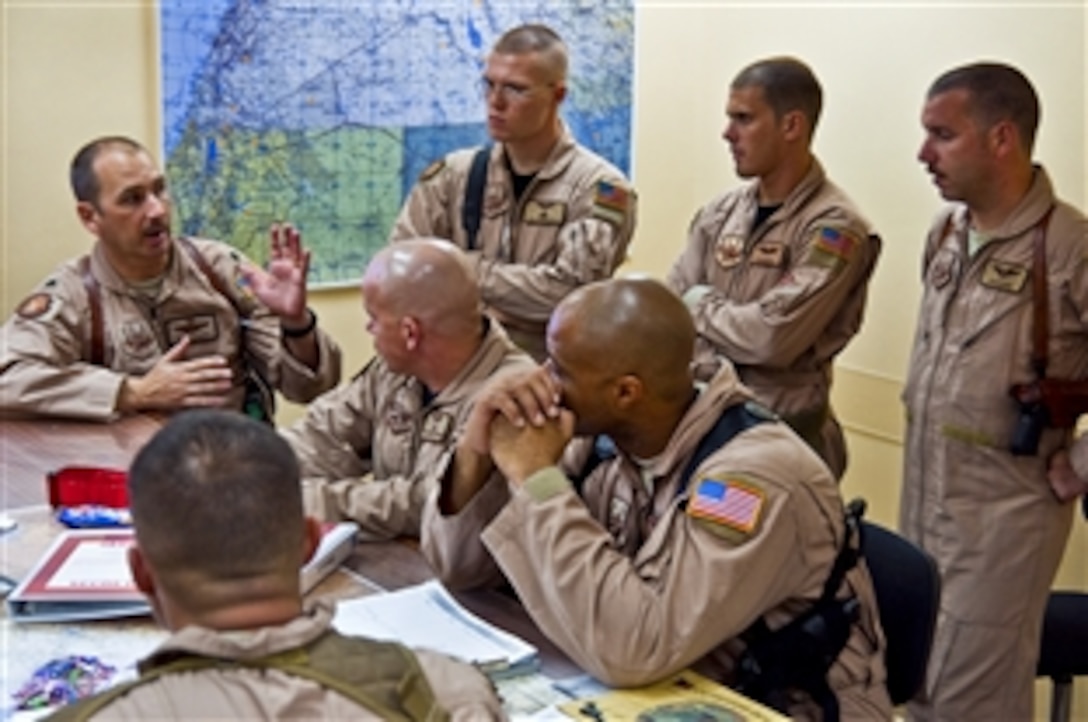 U.S. Air Force Lt. Col. Mark Leavitt, far left, mission commander, conducts a pre-flight briefing at an undisclosed base in Southwest Asia, Aug. 30, 2010, as airmen prepare to fly relief supplies into Pakistan. Record-setting monsoons have killed more than 1,600 Pakistanis and left more than 2 million homeless. The airmen, assigned to the 386th Air Expeditionary Wing, will be based on Bagram Air Field, Afghanistan, for the relief mission.