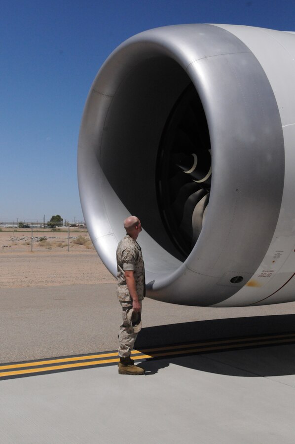 Lance Cpl. Brandon W. Keilers, Harrier power line mechanic with Marine Attack Squadron 513, looks into one of the engines of an experimental version of the Boeing 787 Dreamliner testing at the Yuma International Airport's Defense Contractor Complex on the other side of the air station’s flight line Sept. 1, 2010. Being tested in Yuma due to the high temperatures, the airplane is built primarily of lighter composite materials reducing fuel consumption by 20 percent. Testing is expected to continue in Yuma until mid-September, and is expected to be in service by early 2011, said Monte Martin, Boeing test director.