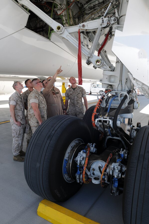 Enlisted Harrier maintainers from Marine Attack Squadron 513 examine the landing gear of an experimental version of the Boeing 787 Dreamliner testing at the Yuma International Airport's Defense Contractor Complex on the other side of the air station’s flight line Sept. 1, 2010. Being tested in Yuma due to the high temperatures, the airplane is built primarily of lighter composite materials reducing fuel consumption by 20 percent. Testing is expected to continue in Yuma until mid-September, and is expected to be in service by early 2011, said Monte Martin, Boeing test director.