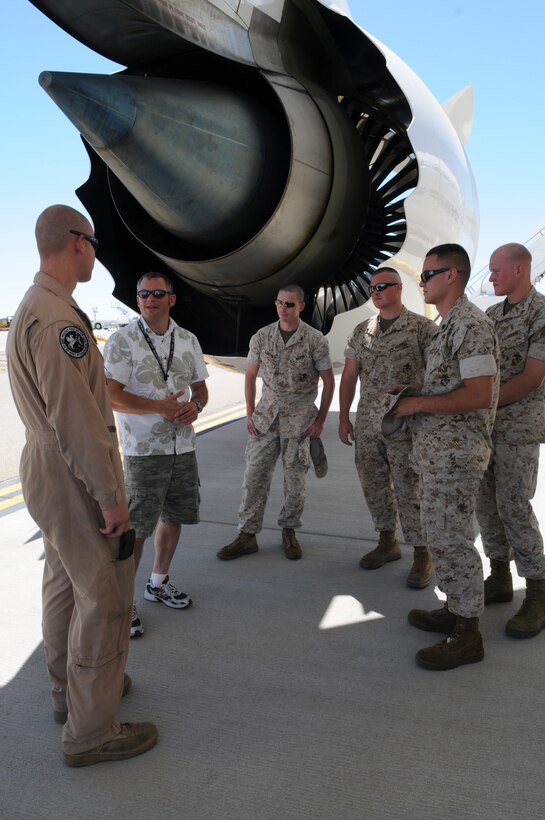 Monte Martin, Boeing test director, speaks with enlisted Harrier maintainers from Marine Attack Squadron 513 under the wing of an experimental version of the Boeing 787 Dreamliner testing at the Yuma International Airport's Defense Contractor Complex on the other side of the air station’s flight line Sept. 1, 2010. Being tested in Yuma due to the high temperatures, the airplane is built primarily of lighter composite materials reducing fuel consumption by 20 percent. Testing is expected to continue in Yuma until mid-September, and is expected to be in service by early 2011, said Martin.