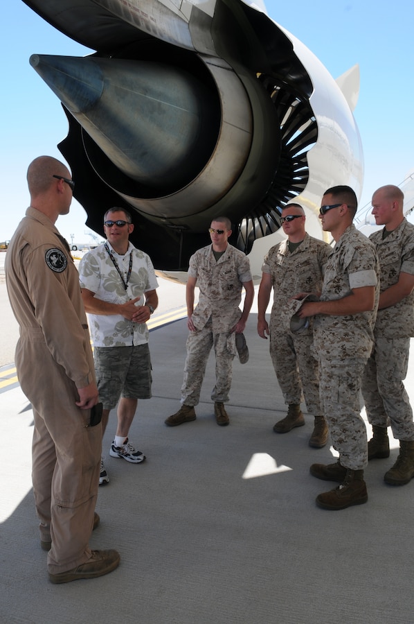 Monte Martin, Boeing test director, speaks with enlisted Harrier maintainers from Marine Attack Squadron 513 under the wing of an experimental version of the Boeing 787 Dreamliner testing at the Yuma International Airport's Defense Contractor Complex on the other side of the air station’s flight line Sept. 1, 2010. Being tested in Yuma due to the high temperatures, the airplane is built primarily of lighter composite materials reducing fuel consumption by 20 percent. Testing is expected to continue in Yuma until mid-September, and is expected to be in service by early 2011, said Martin.
