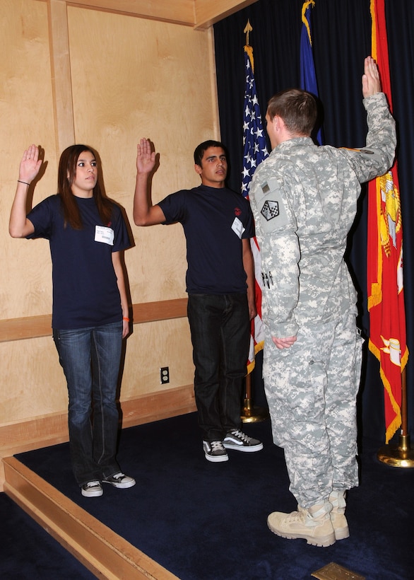 Siblings Ariel and Darrin Martinez take the Oath of Enlistment for the United States Marine Corps at the Military Entrance Processing Station aboard Fort Sam Houston, in San Antonio, Dec. 1, 2010.  The Pleasanton High School seniors, separated by only nine months and 18 days, both took the Oath of Enlistment the same day.