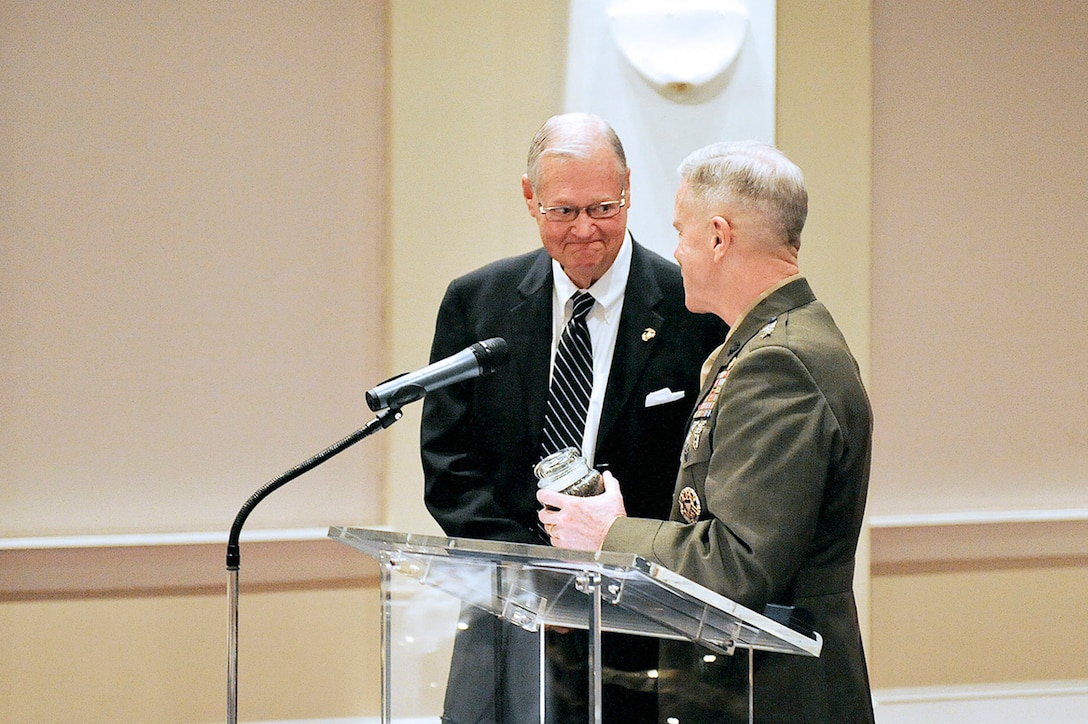 The commandant of the Marine Corps, General James F. Amos presents Rep. Ike Skelton with the title of honorary Marine on Dec. 1, 2010 at Crawford Hall, Marine Barracks, Washington, D.C.