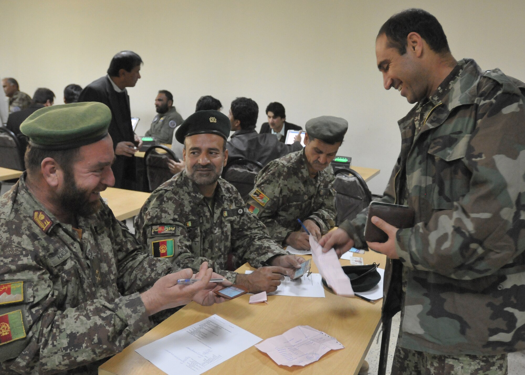 KABUL, Afghanistan – Afghan Air Force Airmen and civilian contractors perform Personnel Accountability Inventory incorporating a Biometrics component to strengthen force accountability and enhance force protection for AAF and Coalition partners Nov. 29 at the Afghan Air Force Base in Kabul, Afghanistan. (US Navy photo by MC2 Vladimir Potapenko/RELEASED).