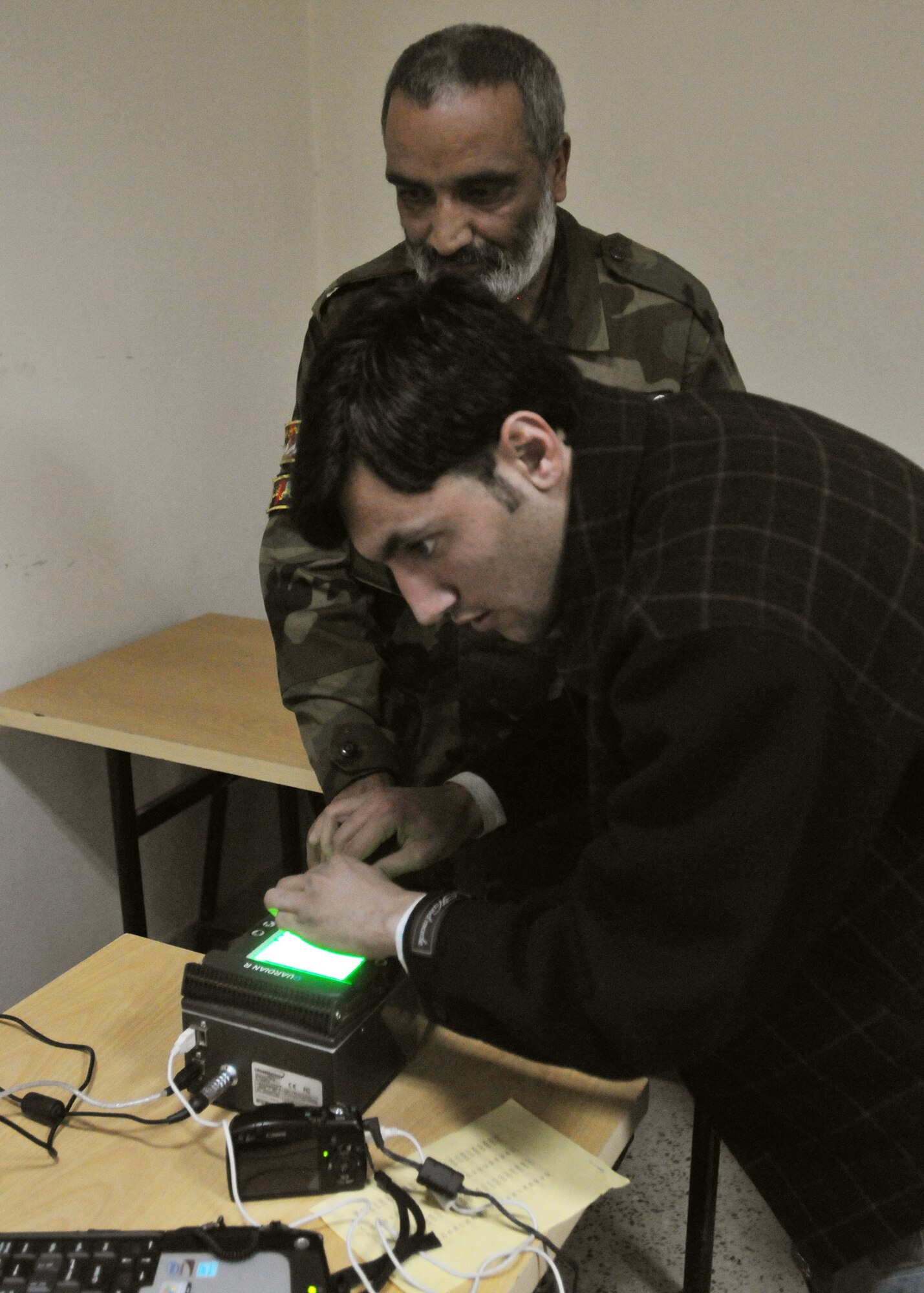 KABUL, Afghanistan – Afghan Air Force Airmen and civilian contractors perform Personnel Accountability Inventory incorporating a Biometrics component to strengthen force accountability and enhance force protection for AAF and Coalition partners Nov. 29 at the Afghan Air Force Base in Kabul, Afghanistan. (US Navy photo by MC2 Vladimir Potapenko/RELEASED).