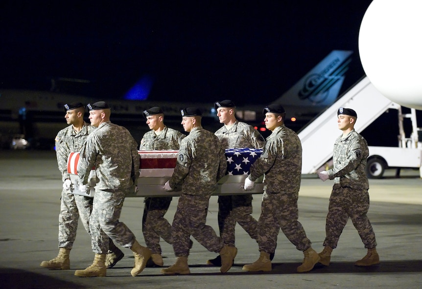 A U.S. Army carry team transfers the remains of Army Pfc. Jacob A. Gassen of Beaver Dam, Wis., at Dover Air Force Base, Del., Dec. 1, 2010.  Gassen was assigned to the 1st Squadron, 61st Cavalry Regiment, 4th Brigade Combat Team, 101st Airborne Division (Air Assault), Fort Campbell, Ky. (U.S. Air Force photo by Jason Minto)