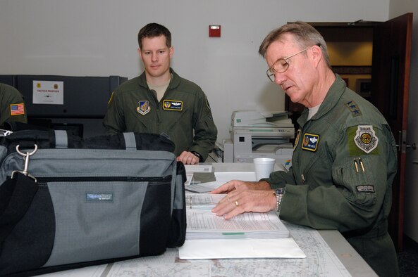 Lt. Gen. Herbert "Hawk" Carlisle, 13th Air Force commander, reviews flight plans for his final flight as 13th AF commander at Joint Base Pearl Harbor Hickam, Hawaii Nov. 30 with Maj. Scott Raleigh, 13th AF C-17 Standards and Evaluations program chief.  General Carlisle's final flight was supported by the 15th Wing's 535th Airlift Squadron here. General Carlisle has been confirmed for assignment as Deputy Chief of Staff, Operations, Plans and Requirements, Headquarters U.S. Air Force, Washington, D.C. (U.S. Air Force photo by Mark Bates)