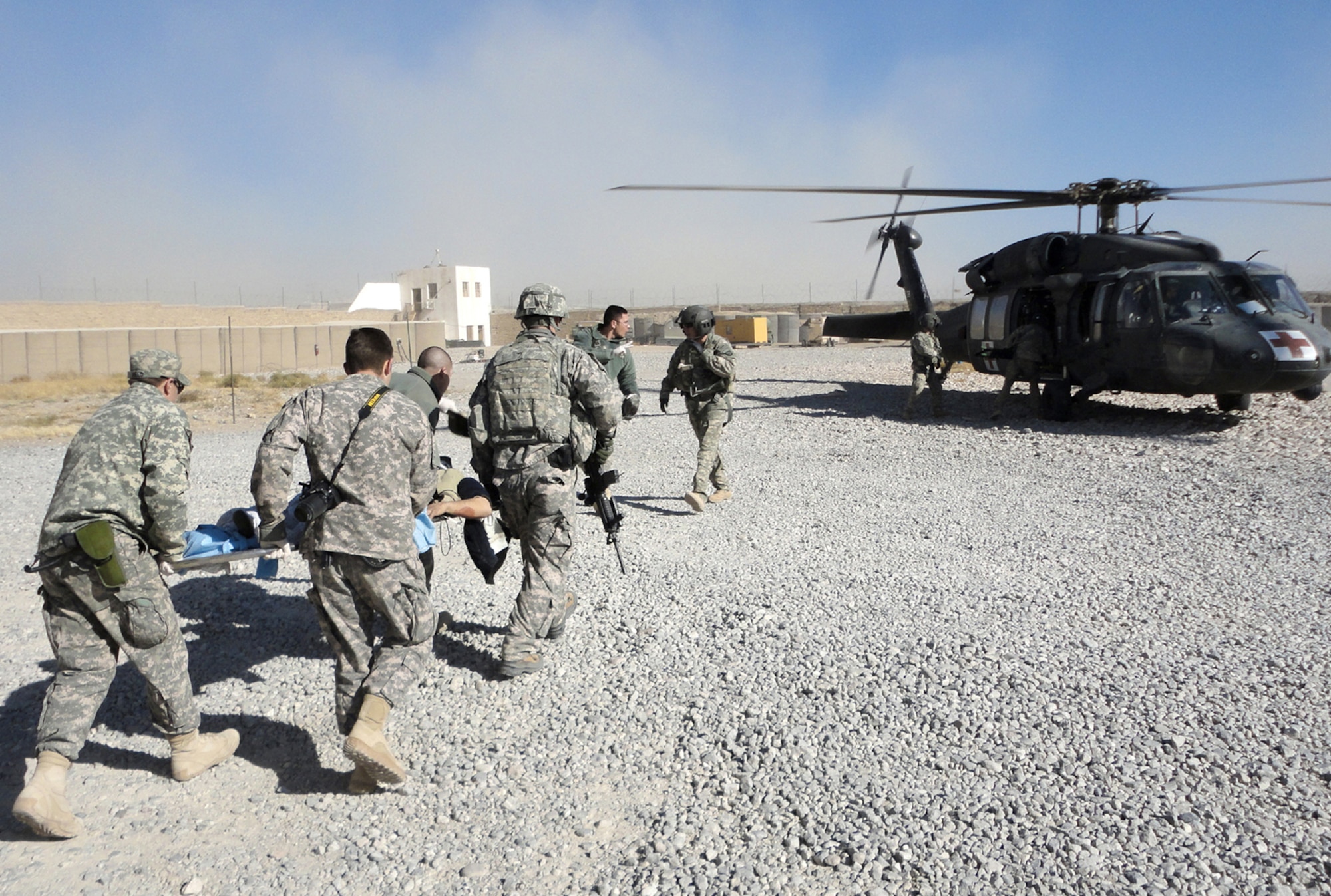 Airmen and Soldiers from Provincial Reconstruction Team Zabul load a patient onto a medevac helicopter after a civilian bus rolled over, leaving seven dead and more than 30 injured Nov. 30, 2010, just outside Qalat City, Afghanistan. Medical personnel from the PRT were on the scene at Zabul Provincial Hospital to assess patients and provide medical care. Nine patients with potentially life-threatening injuries were flown via helicopter from Forward Operating Base Smart to FOB Lagman, and then on to Kandahar. (U.S. Air Force photo/1st Lt. Brian Wagner) 