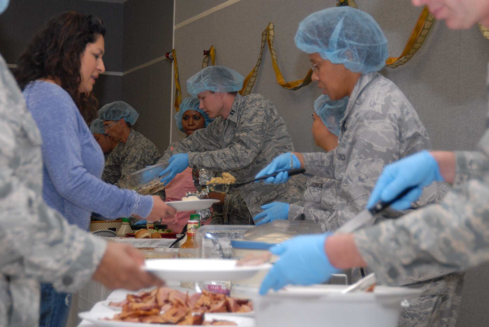 Col. Janet Taylor, 95th Medical Group commander, serves Thanksgiving favorites to members of the 95th MDG and their families. The 95 MDG held its annual Thanksgiving Luncheon, Nov. 19, to celebrate the holiday and recognize winners of the Air Force Materiel Command Medical Service awards. (Air Force Photo by Kate Blais)