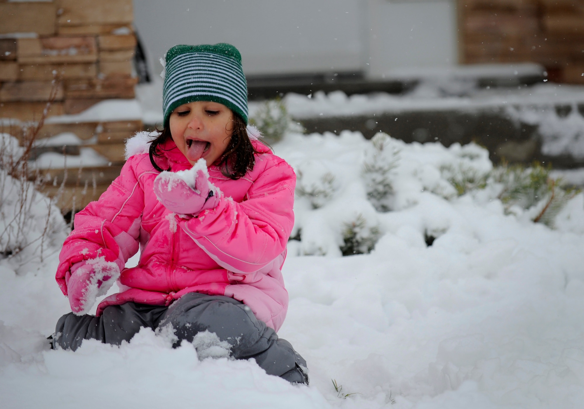 MOUNTAIN HOME AIR FORCE BASE, Idaho -- Tristen, 5, prepares to eat a handful of snow Dec. 1. Due to the inclement weather and bad road conditions schools on base and in town were canceled today. (U.S. Air Force photo by Senior Airman Renishia Richardson)