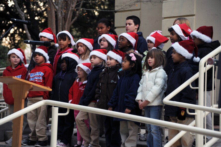 The children?s choir performs during the Christmas tree lighting ceremony at Chapel 1 on Barksdale Air Force Base, La., Nov. 30. At the end of the ceremony, a switch was flipped to light the Christmas tree and the festively decorated 2nd Bomb Wing Headquarters building. (U.S. Air Force photo/Senior Airman Brittany Y. Bateman)(RELEASED)